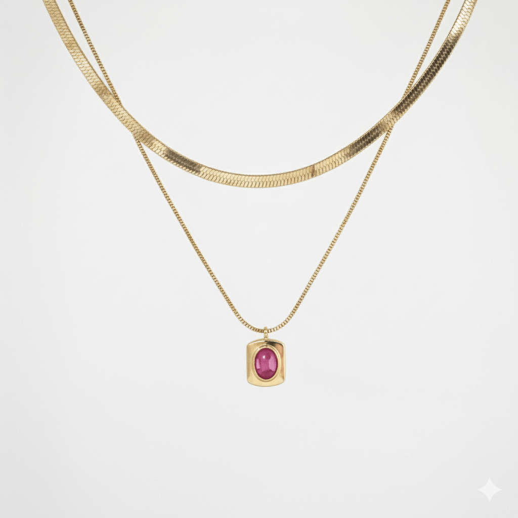 Layered snake chain necklace with a pink gemstone pendant