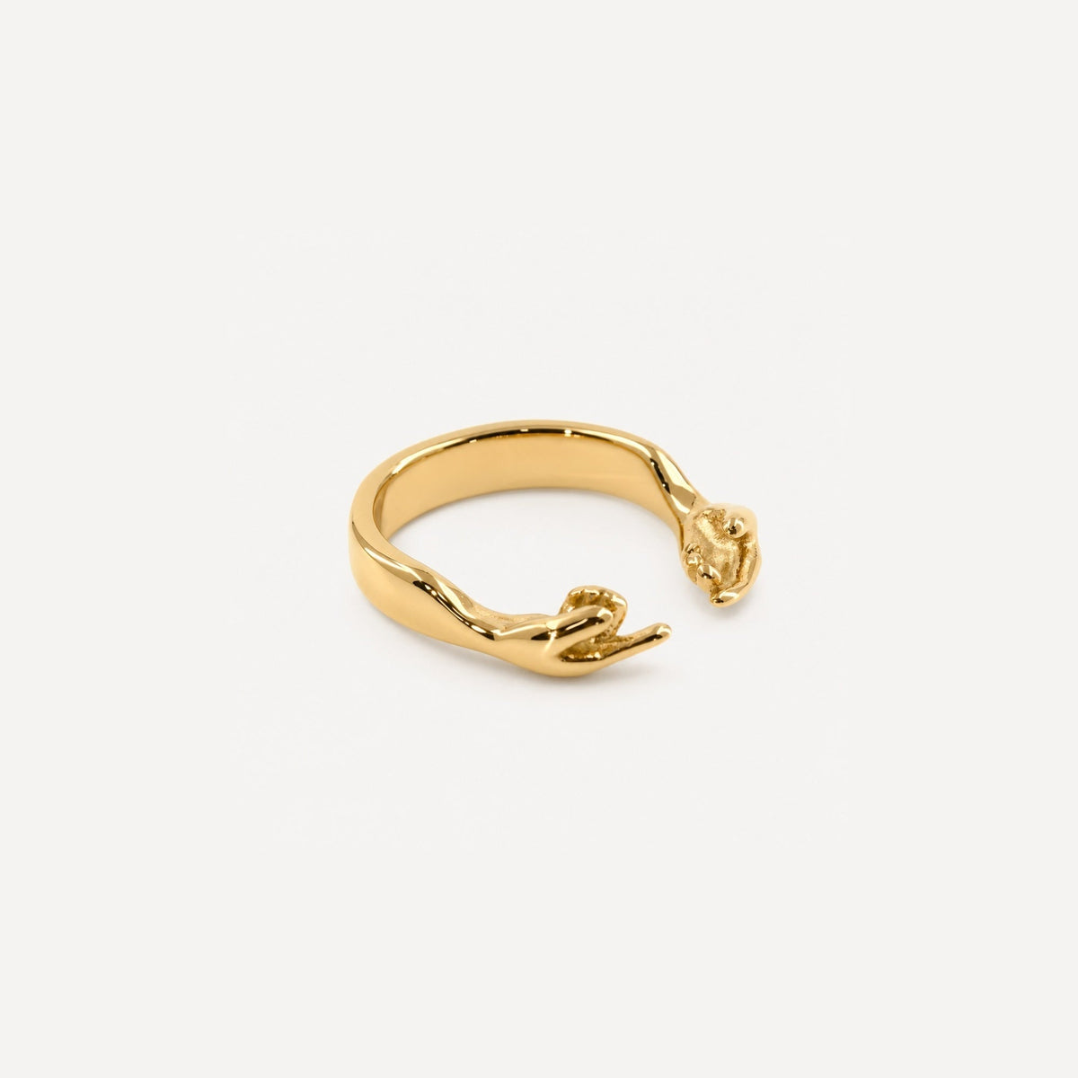 Gold open hands ring