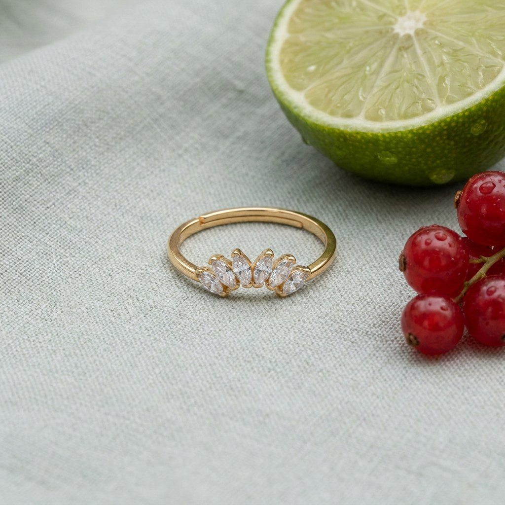 Contour Gemstone Band Ring on pale grey-green linen beside a halved lime and red currants
