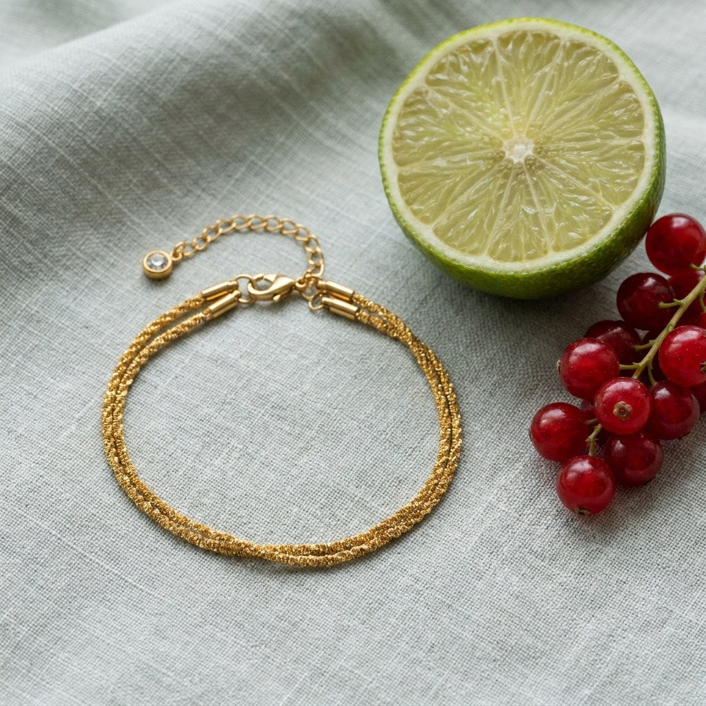 Double Layer Diamond on pale grey-green linen beside a halved lime and red currants