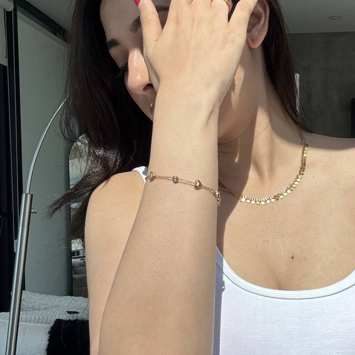 Gold Heart CZ Station Bracelet worn on the wrist