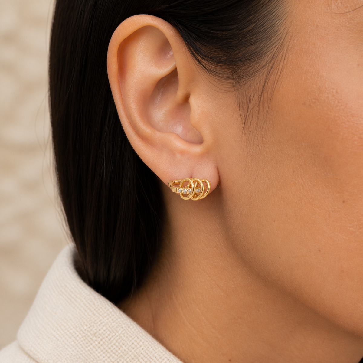 Interlocking Pave Hoops worn — 18k gold-plated 316L stainless steel, water-resistant