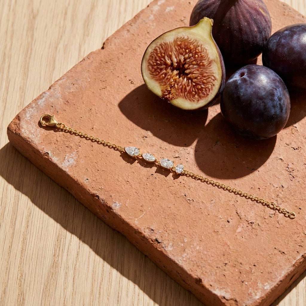 Mixed Cut Diamond Bracelet on a weathered terracotta tile with a cut fig and dark plums