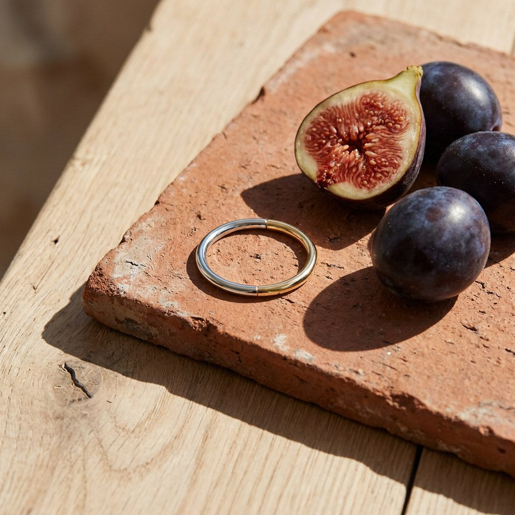 Mixed Thin Ring on a weathered terracotta tile with a cut fig and dark plums