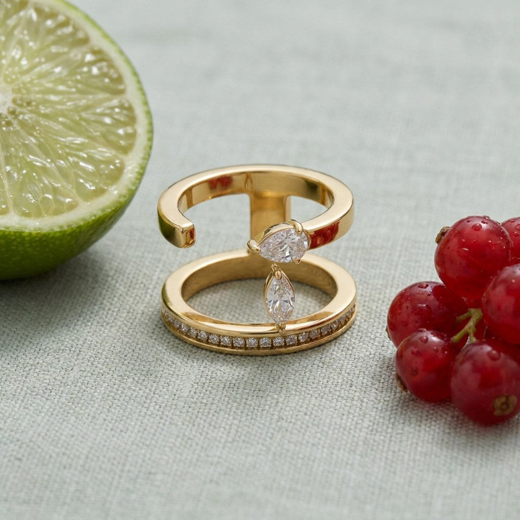 Negative Space Ring on pale grey-green linen beside a halved lime and red currants