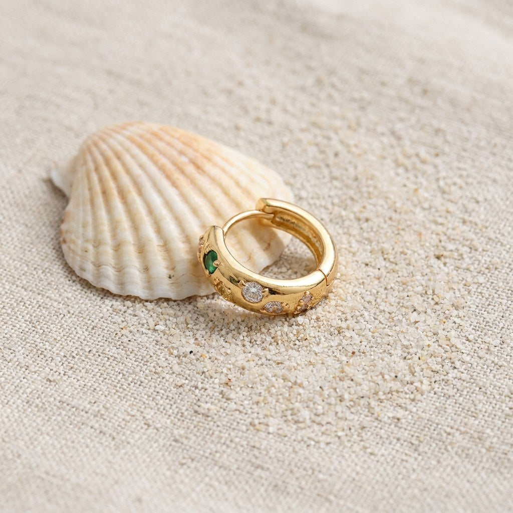 Rainbow Stone Hoop Earrings on raw linen beside a scallop shell and a scatter of fine sand