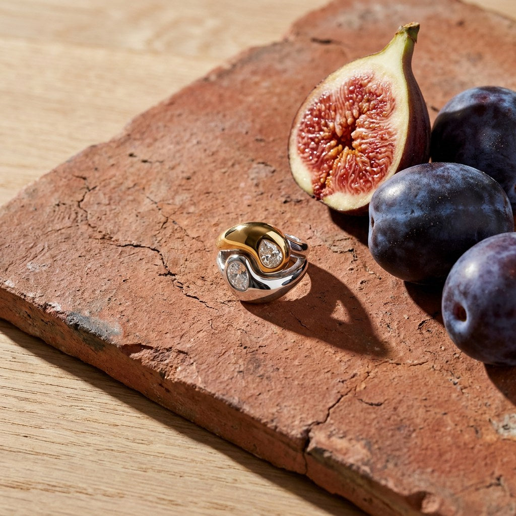 Two on a weathered terracotta tile with a cut fig and dark plums