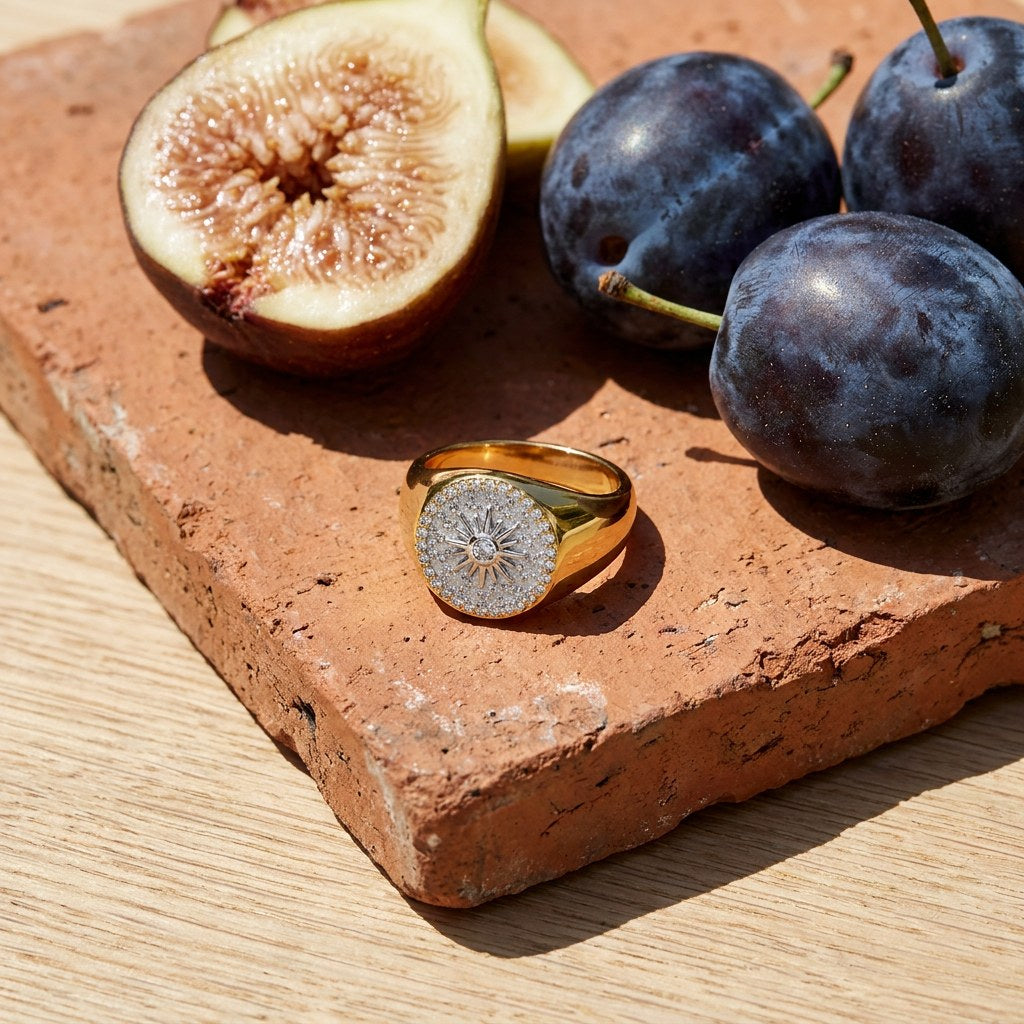 Two on a weathered terracotta tile with a cut fig and dark plums